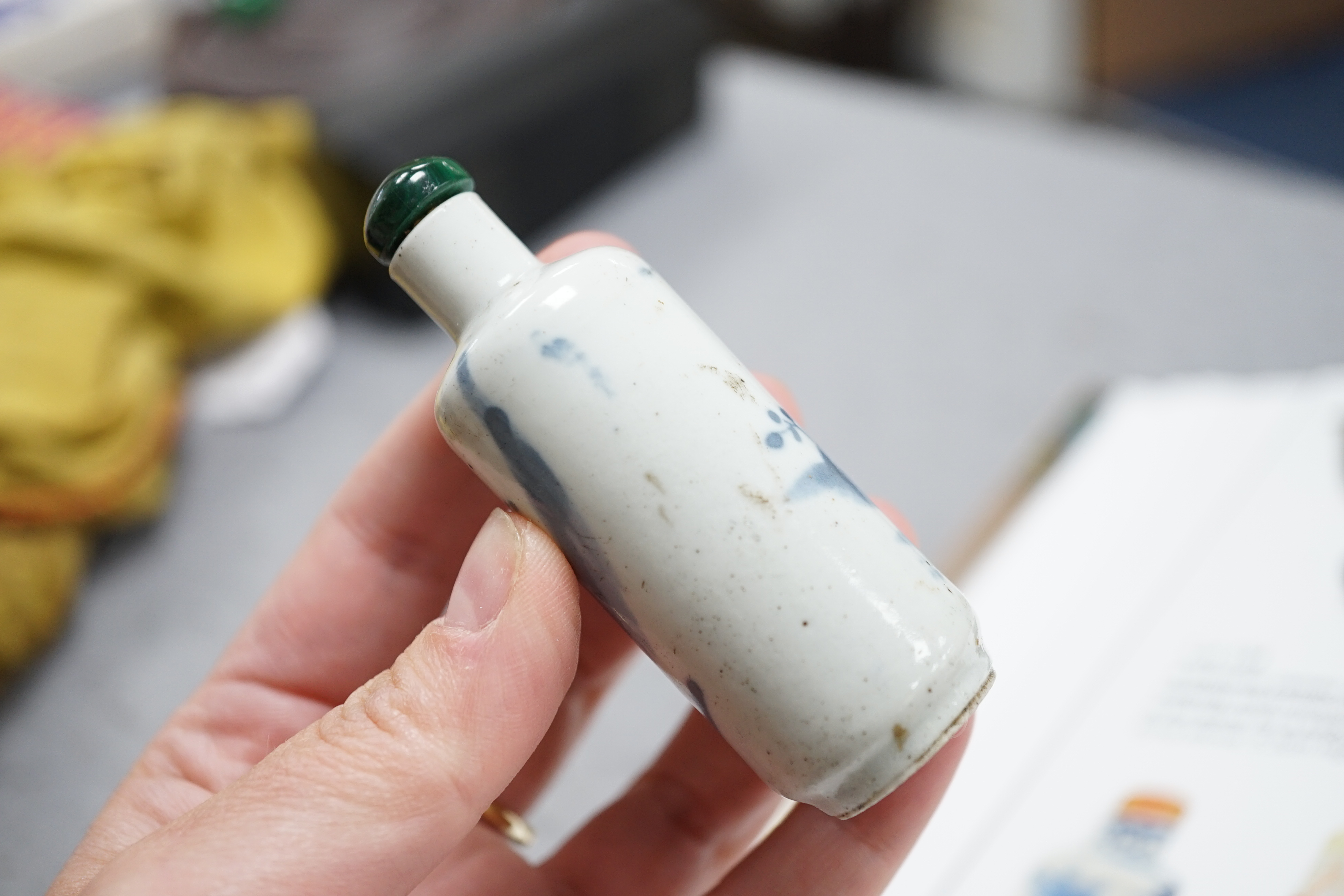 A Chinese iron red enamelled ‘dragon’ snuff bottle, Tongzhi mark and of the period (1862-74), together with two Chinese blue and white cylindrical snuff bottles, 19th century